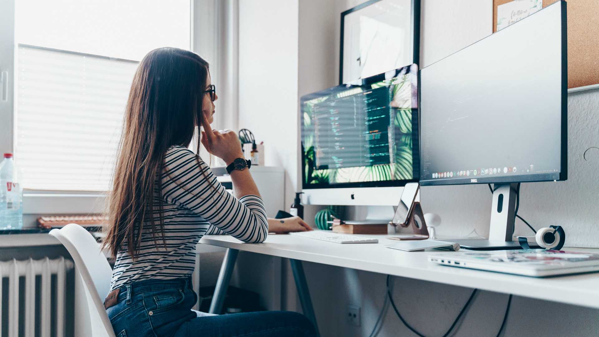 woman coding at a large desk