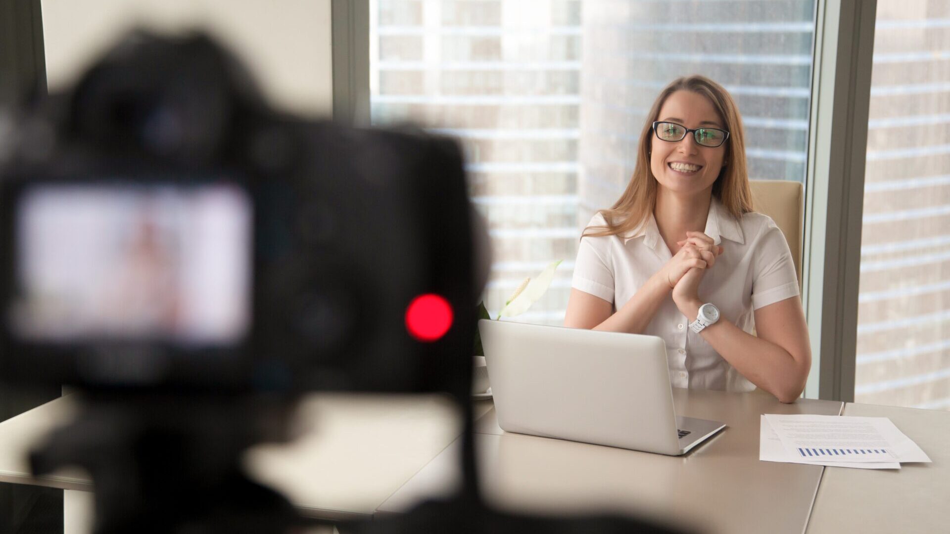 Smiling businesswoman talking on camera