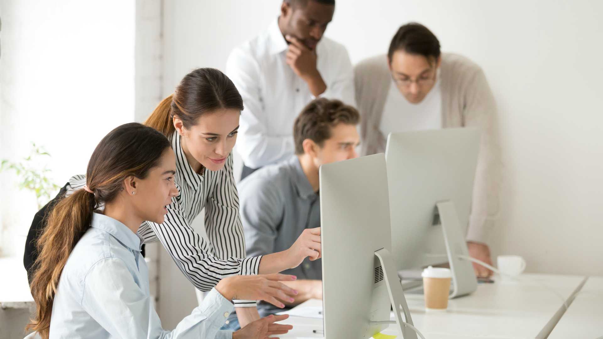 diverse group of professionals collaborating with computers
