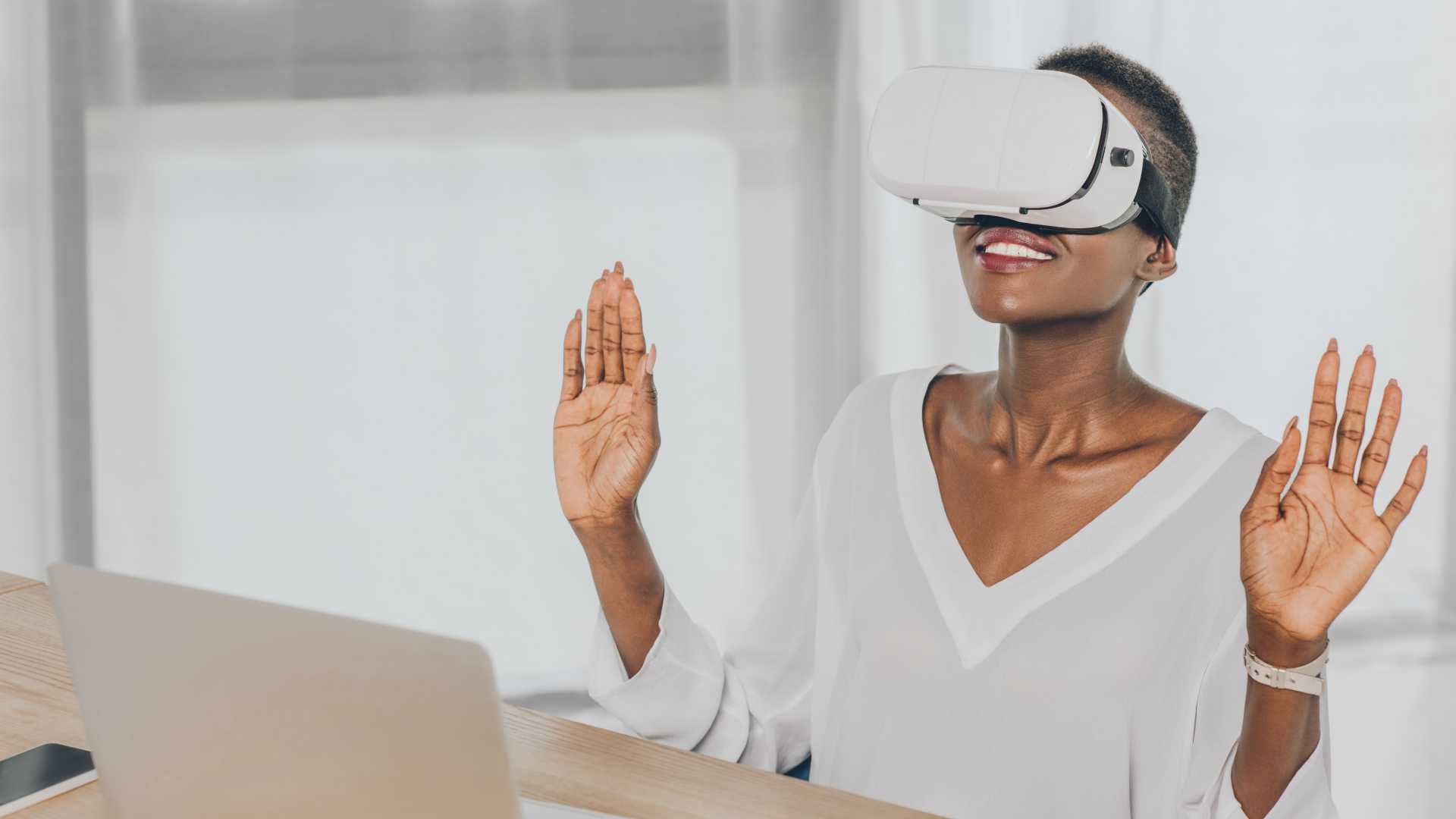 stylish surprised african american businesswoman looking up in virtual reality headset in office