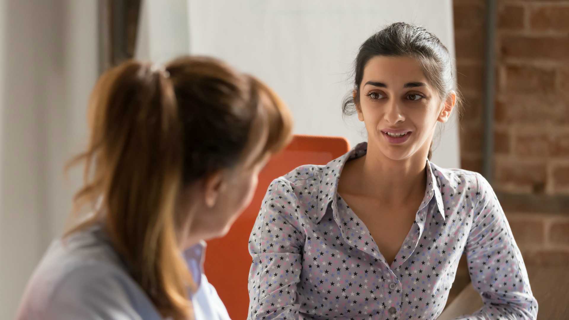 Indian businesswoman speaking to colleague or hr during job interview