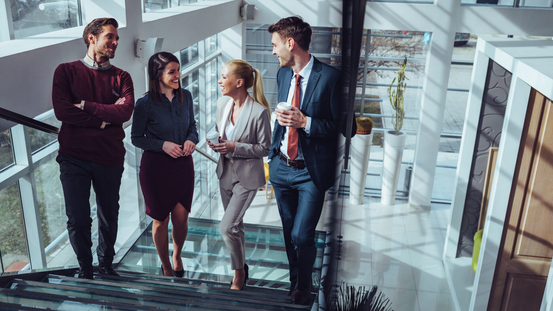 Business team talking to each other while walking up stairs