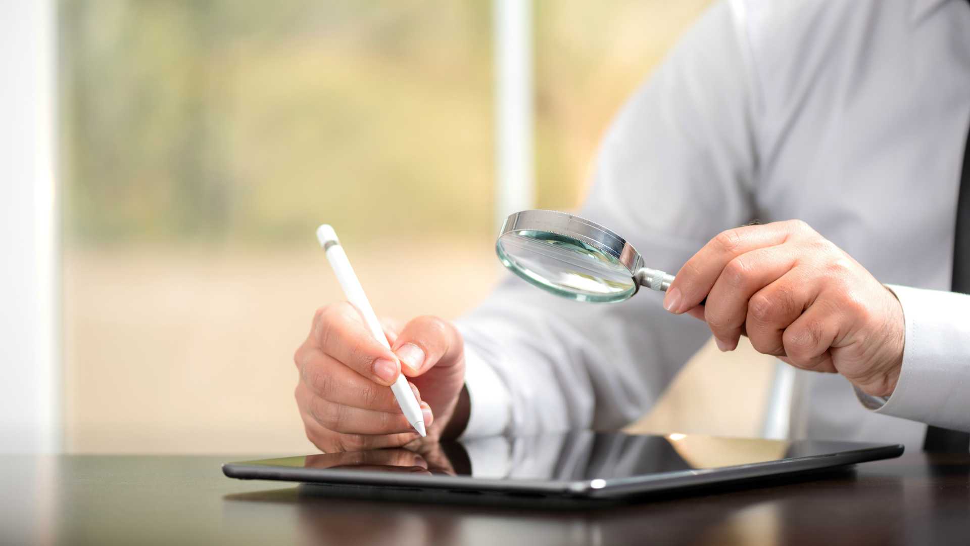 Businessman Reading Contract Details Before Signing Digital Using Tablet And Stylus
