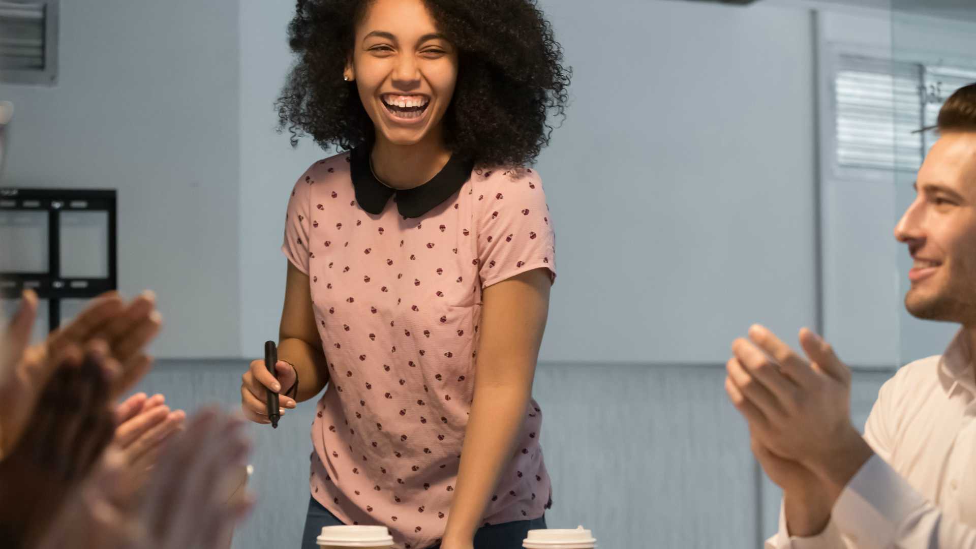 Happy African American female coach or trainer laugh at educational training or briefing