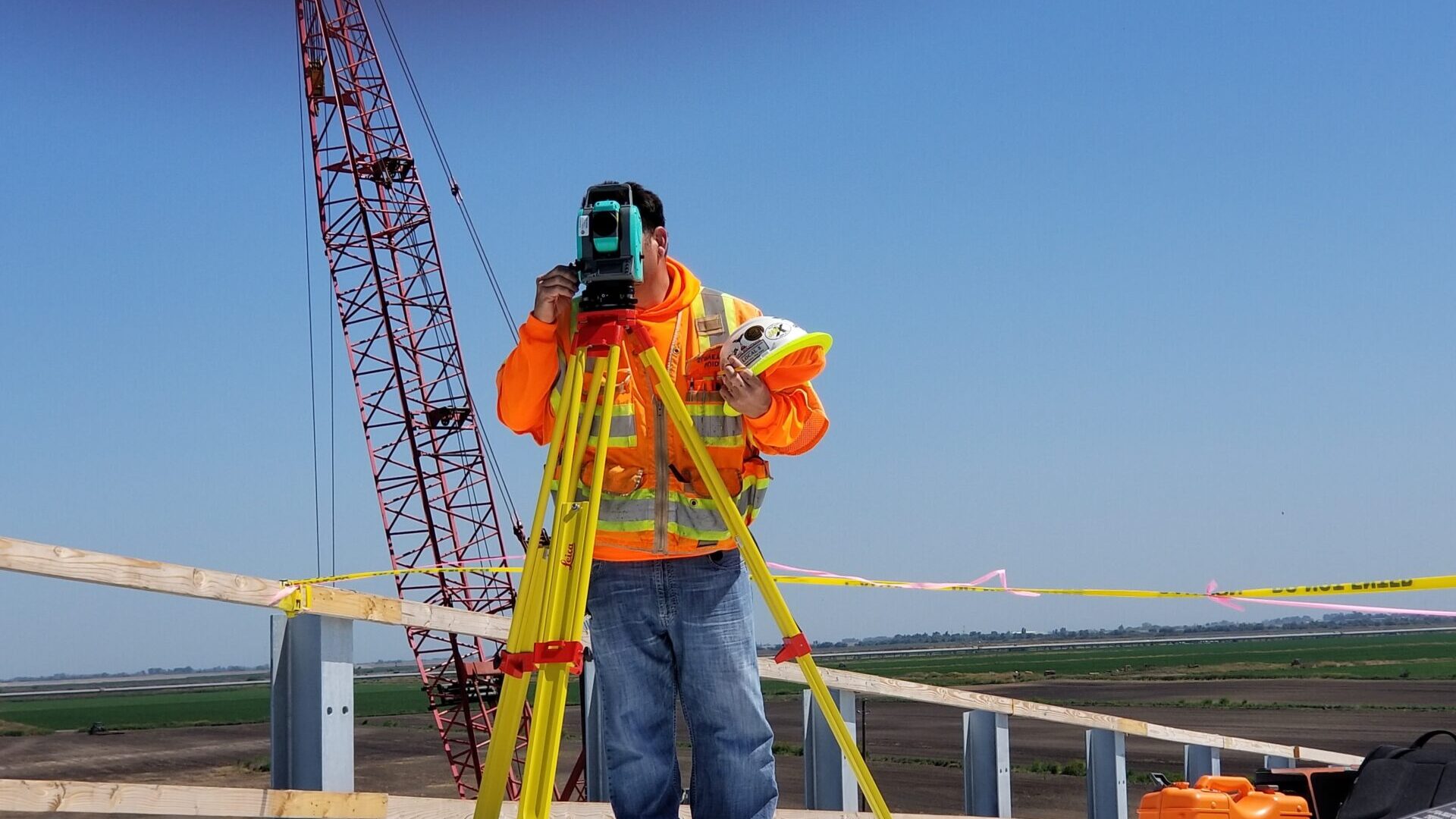 Construction man on job site surveying the site