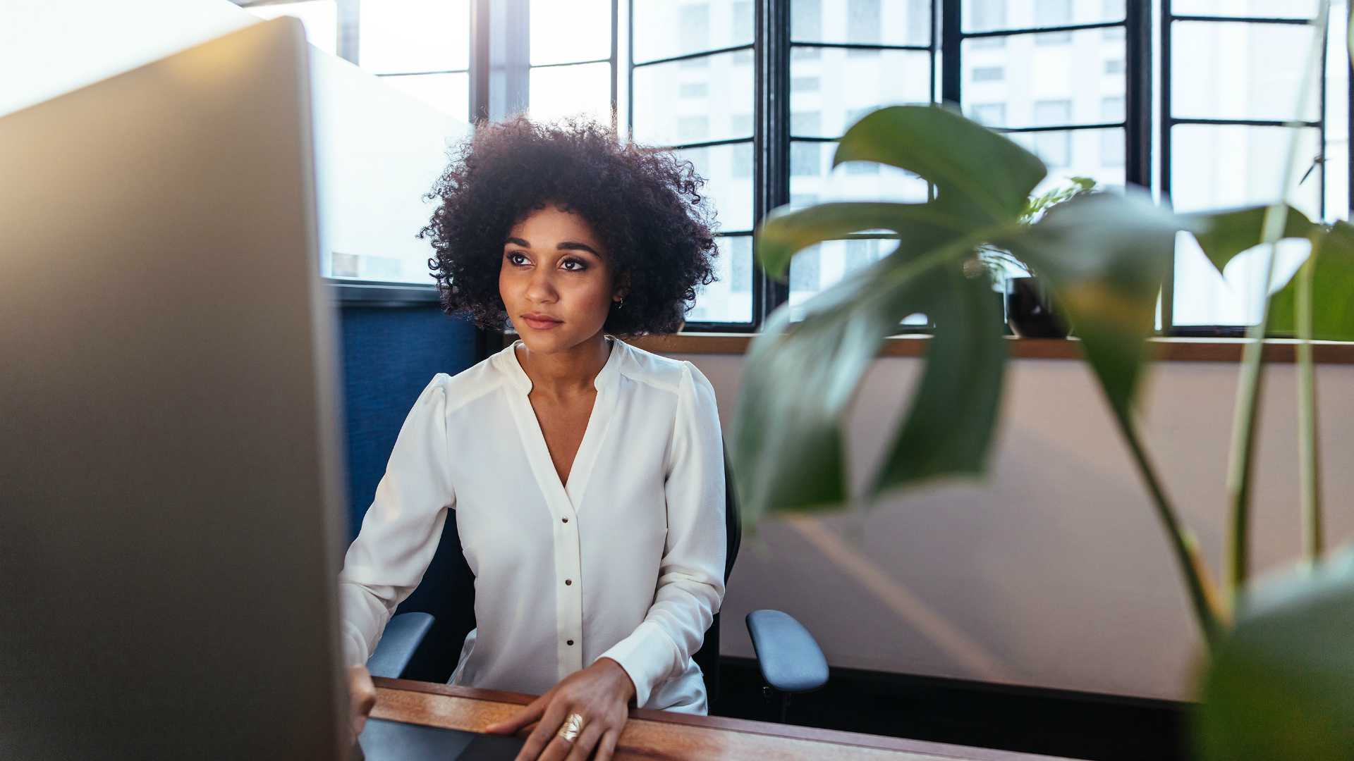Young African American businesswoman working on desktop computer