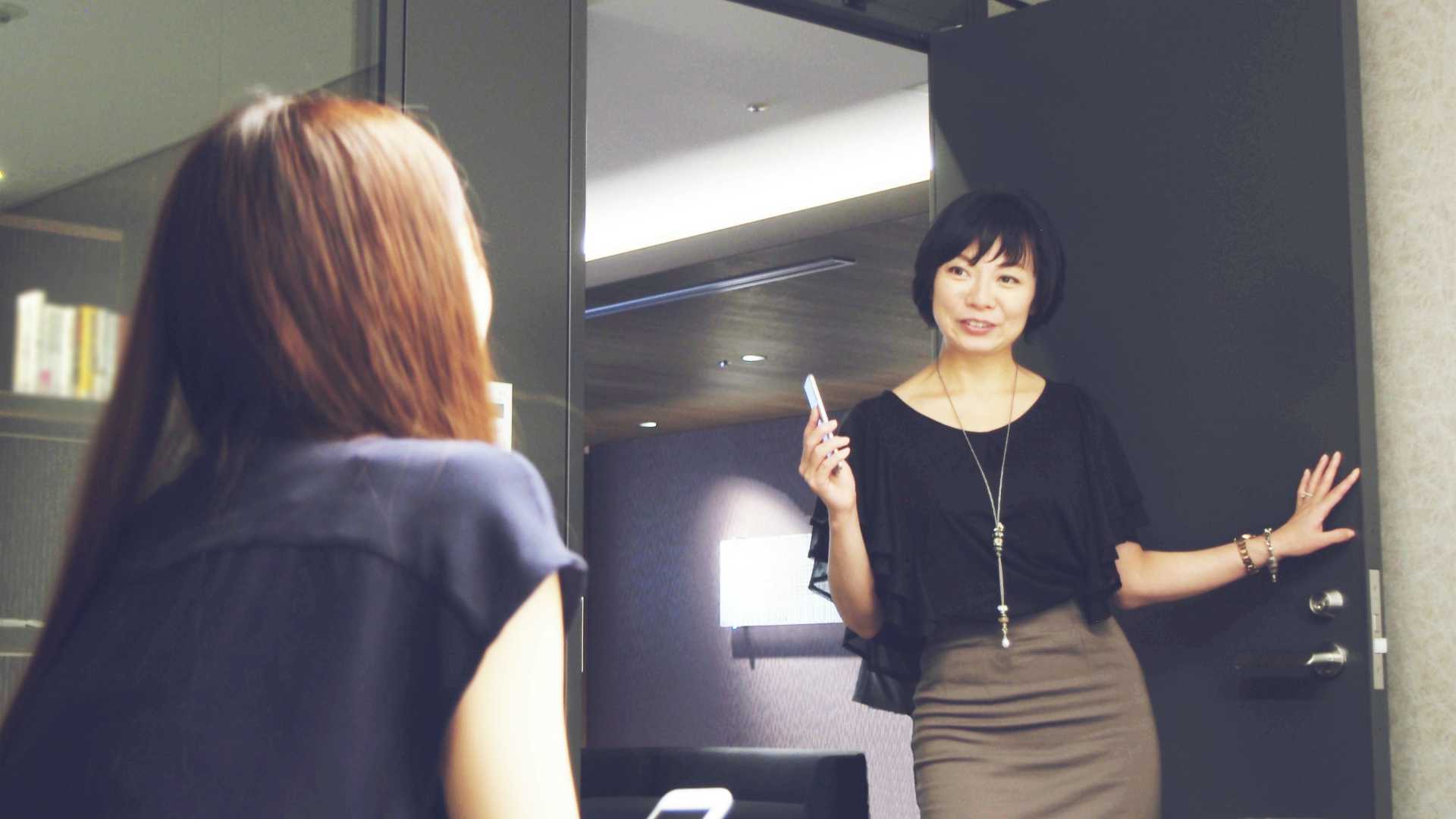 Female manager standing in doorway or female employee's office and asking for update on project