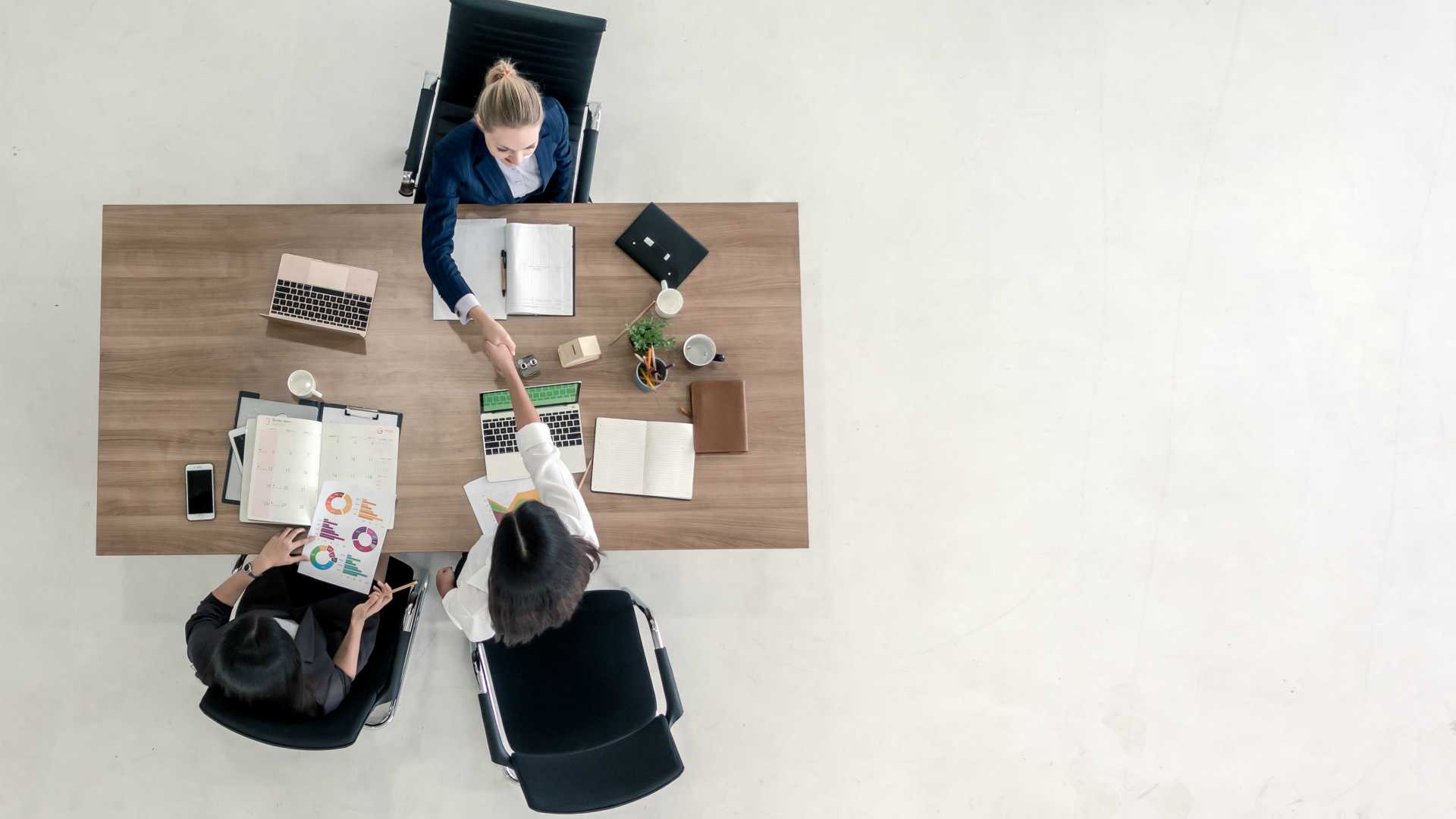 Top view of business people shaking hands after sealing a deal.