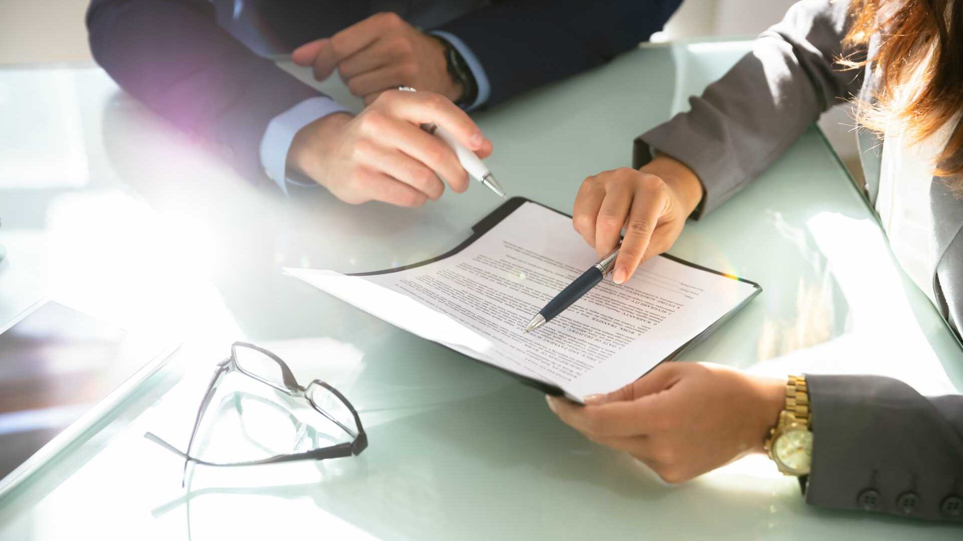 Aerial view of trainer reviewing document with learner