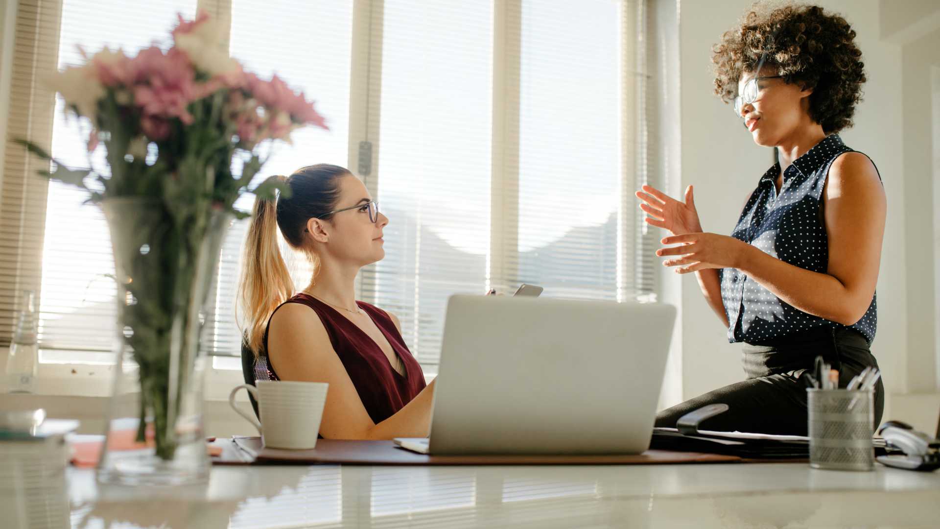 Female business partners discussing over new project in office.
