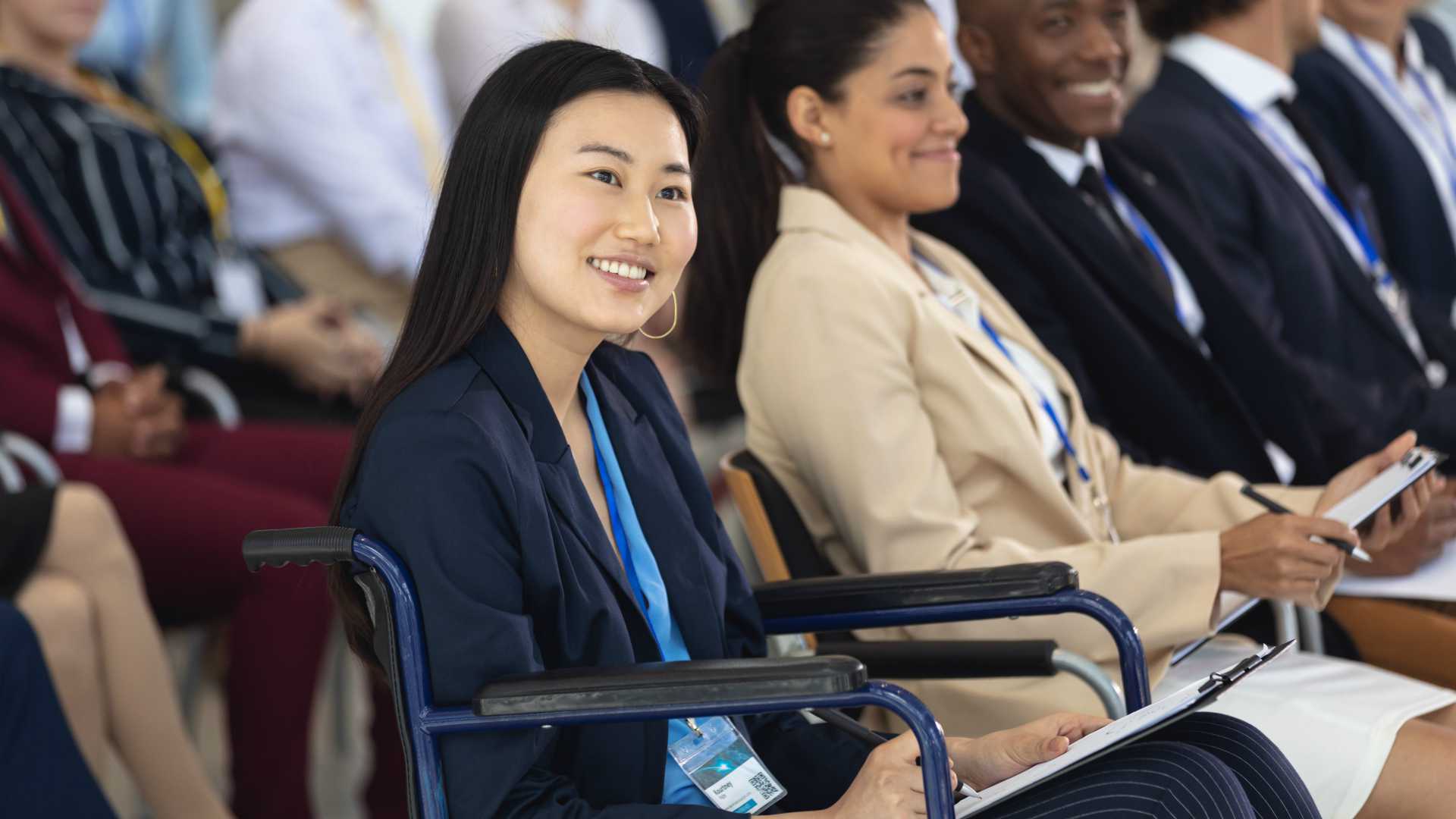 Close up shot of Asian businesswoman in wheelchair attending instructor-led training program