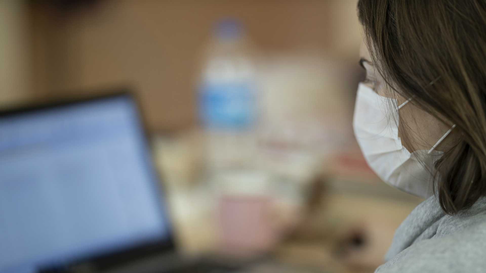 Businesswoman wearing medical face mask and working from home