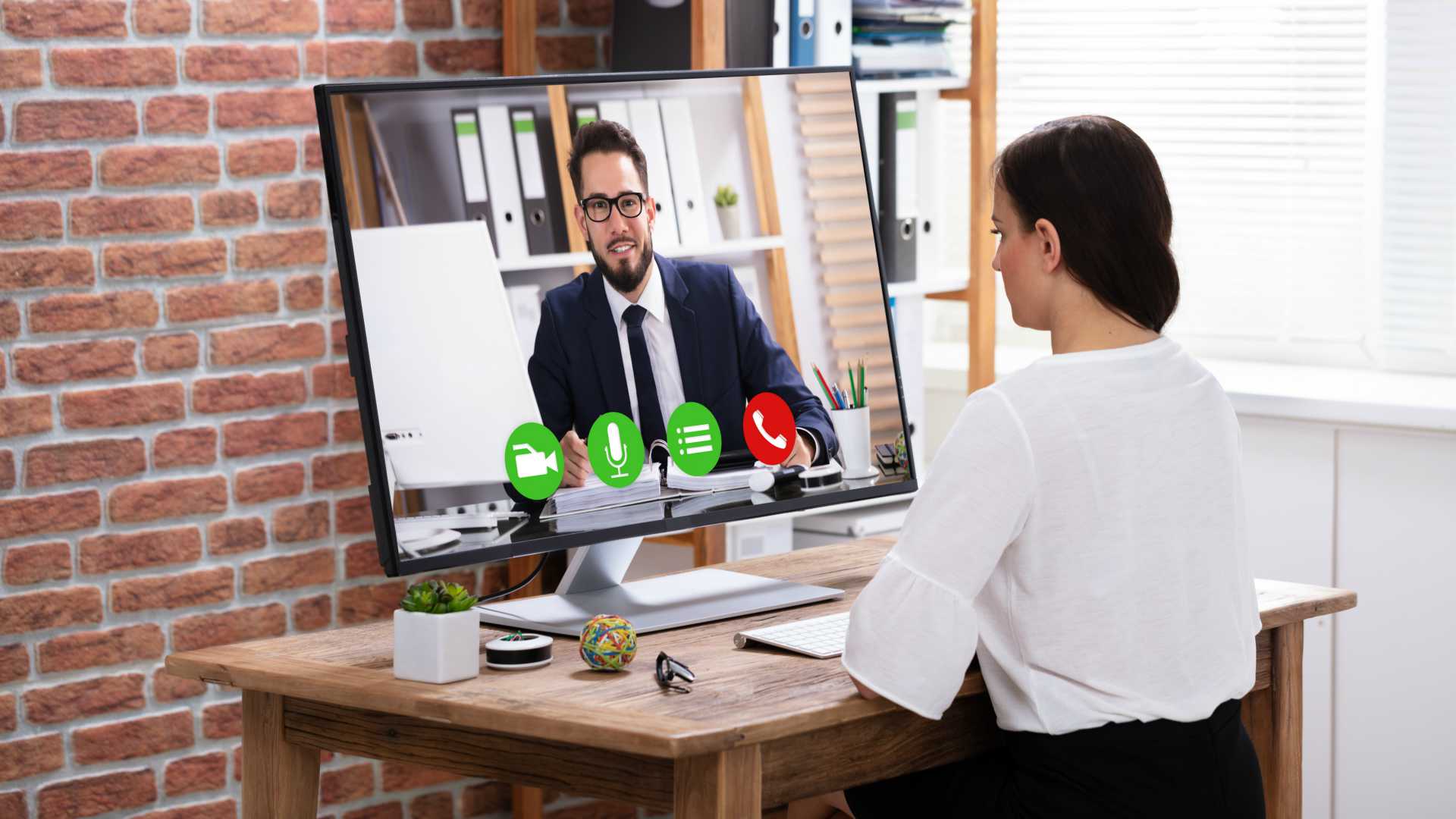 Saleswoman working from home office, video conferencing with male business prospect