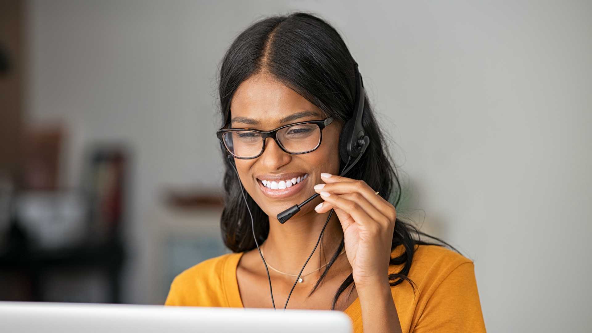 Portrait of cheerful indian woman working from home.