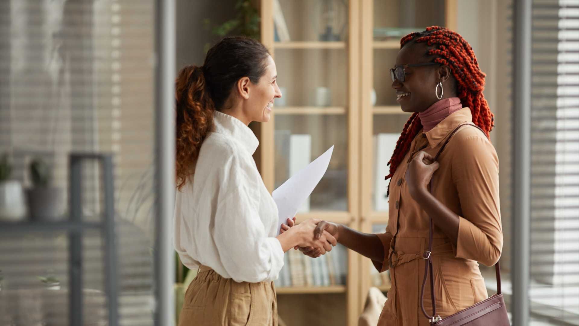 two business women shake hands