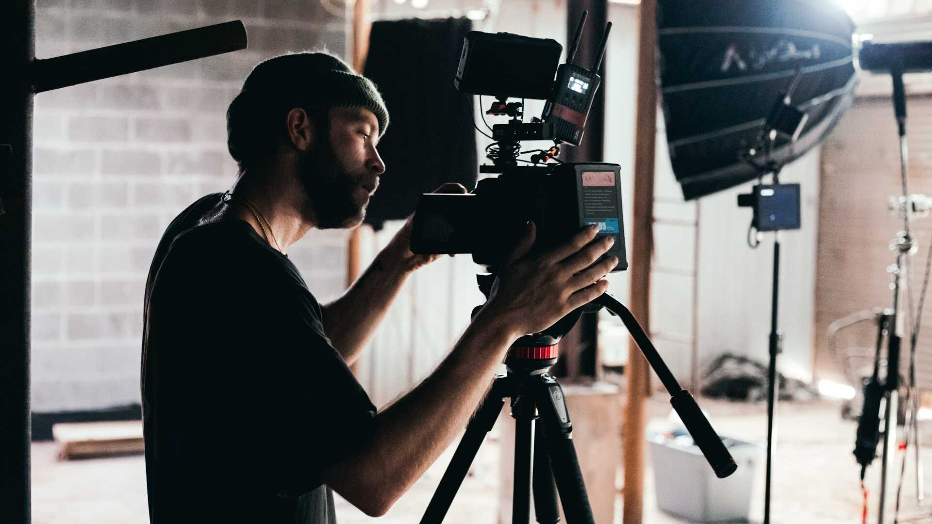 Person looking through the lens of a video camera