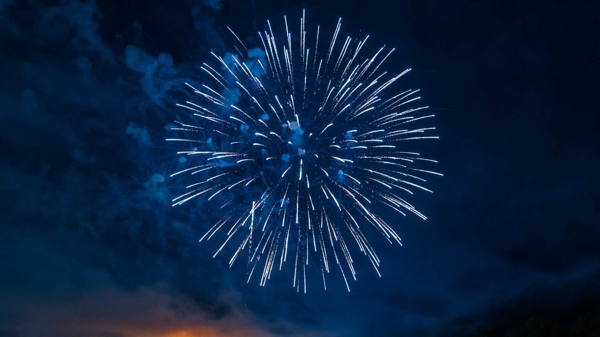 A firework bursts in the sky