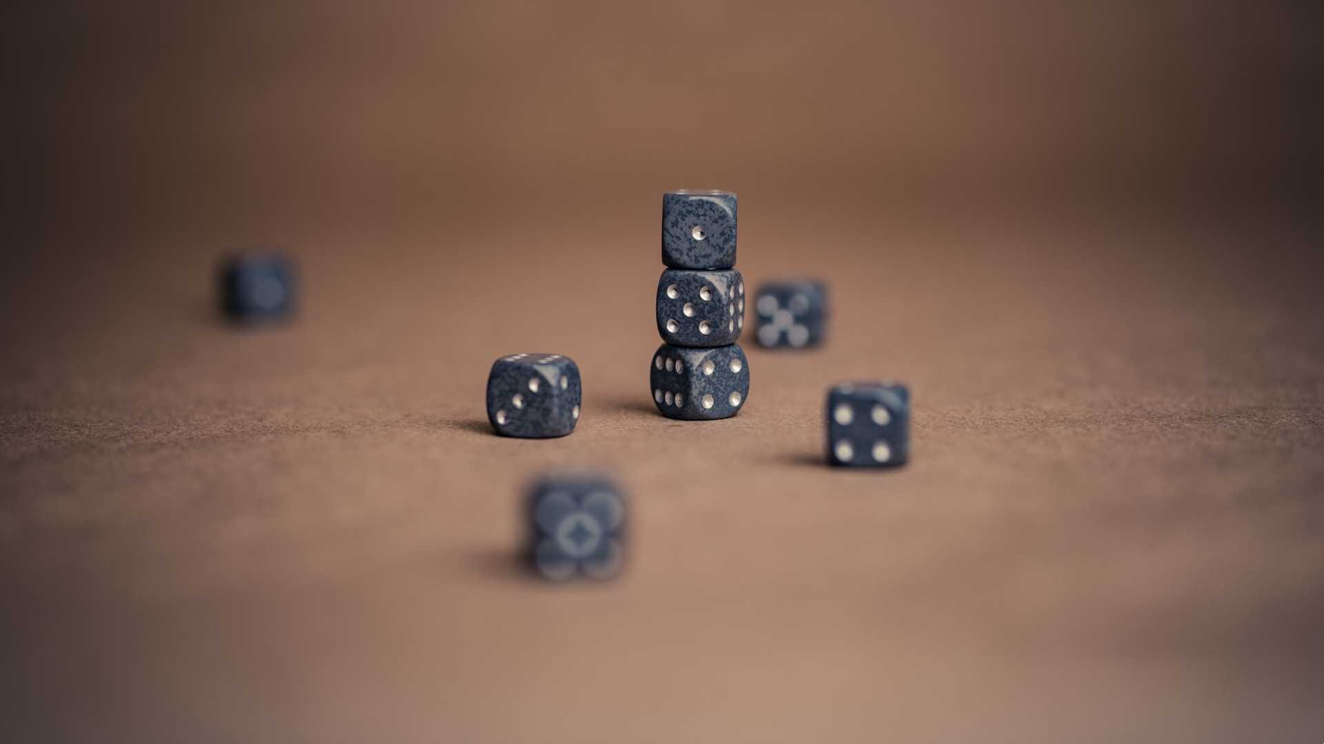 Black dice scattered on a table