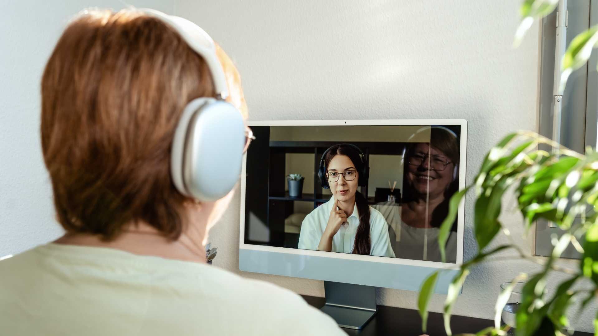 An employee working from home is on a video call with a remote colleague.