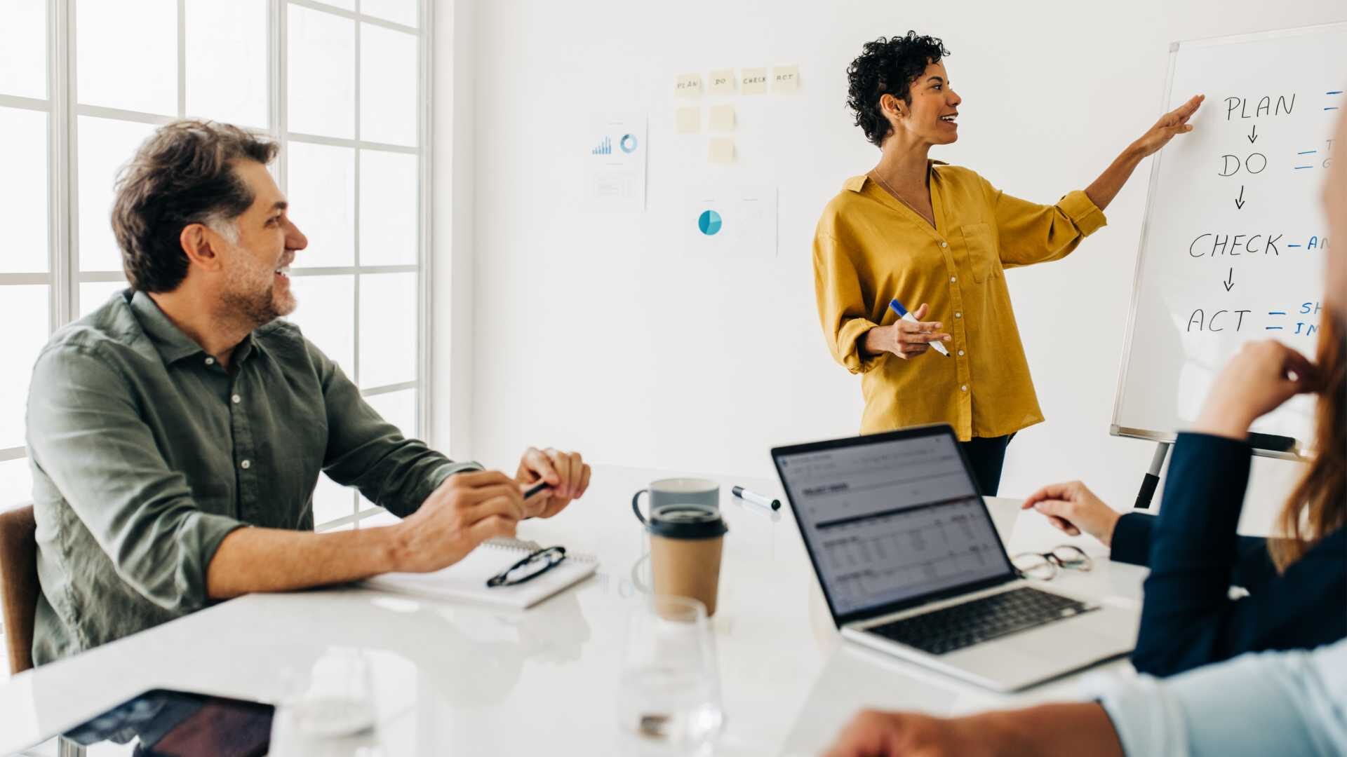 Woman giving a presentation to group of leaders.
