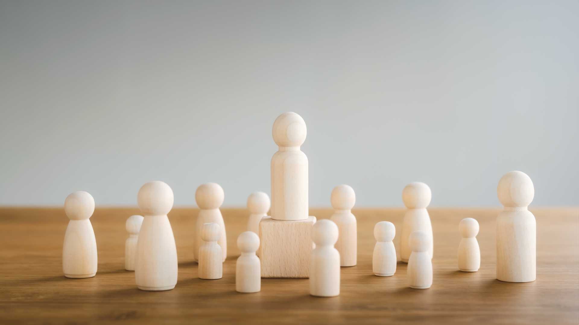 Team work/leadership concept of wooden dolls