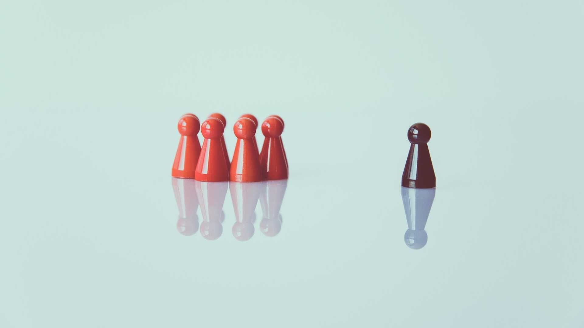A concept of leadership using game pieces against a light blue background