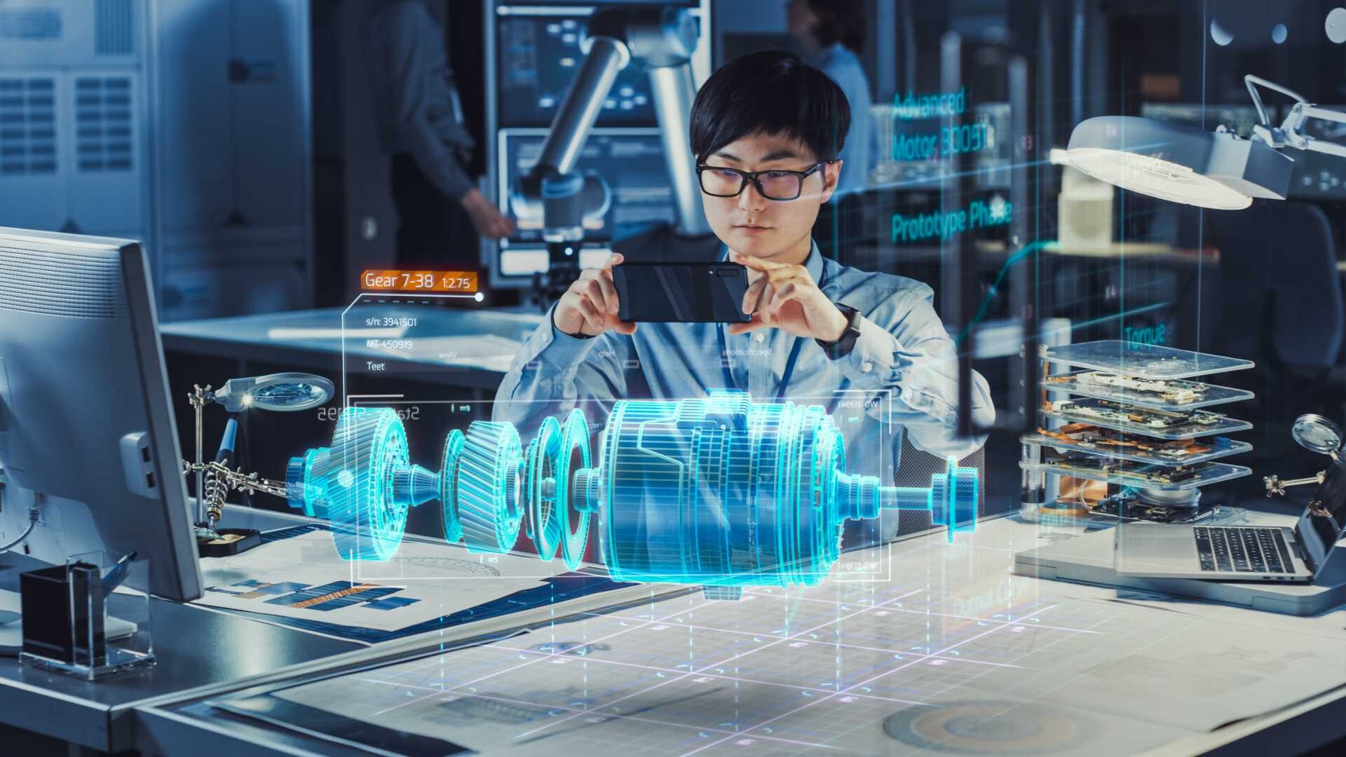 Man using advanced technology, hologram hovering over a table of a manufacturing part.