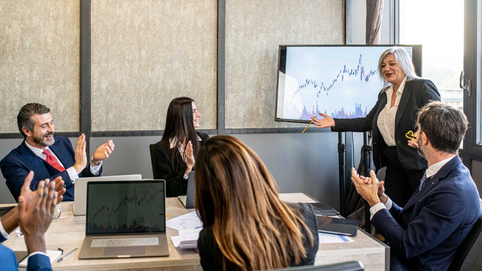 Business meeting, group of multiracial people in office during a presentation of a graph