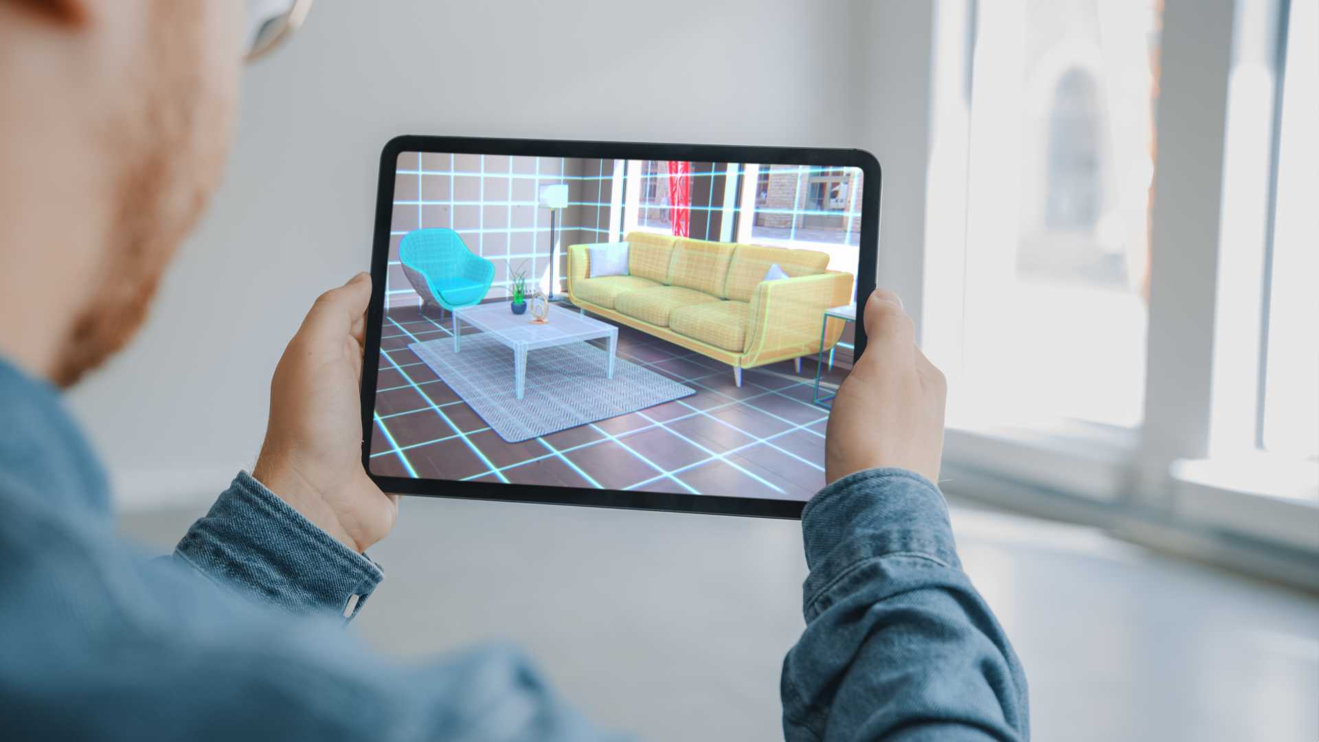 A person Holding a Digital Tablet with AR Interior Design Software Chooses 3D Furniture for Home.