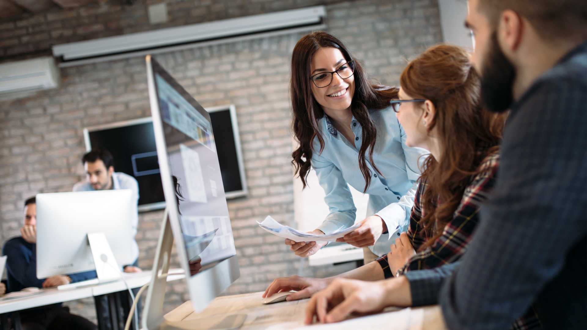 A group of employees collaborate in an office space