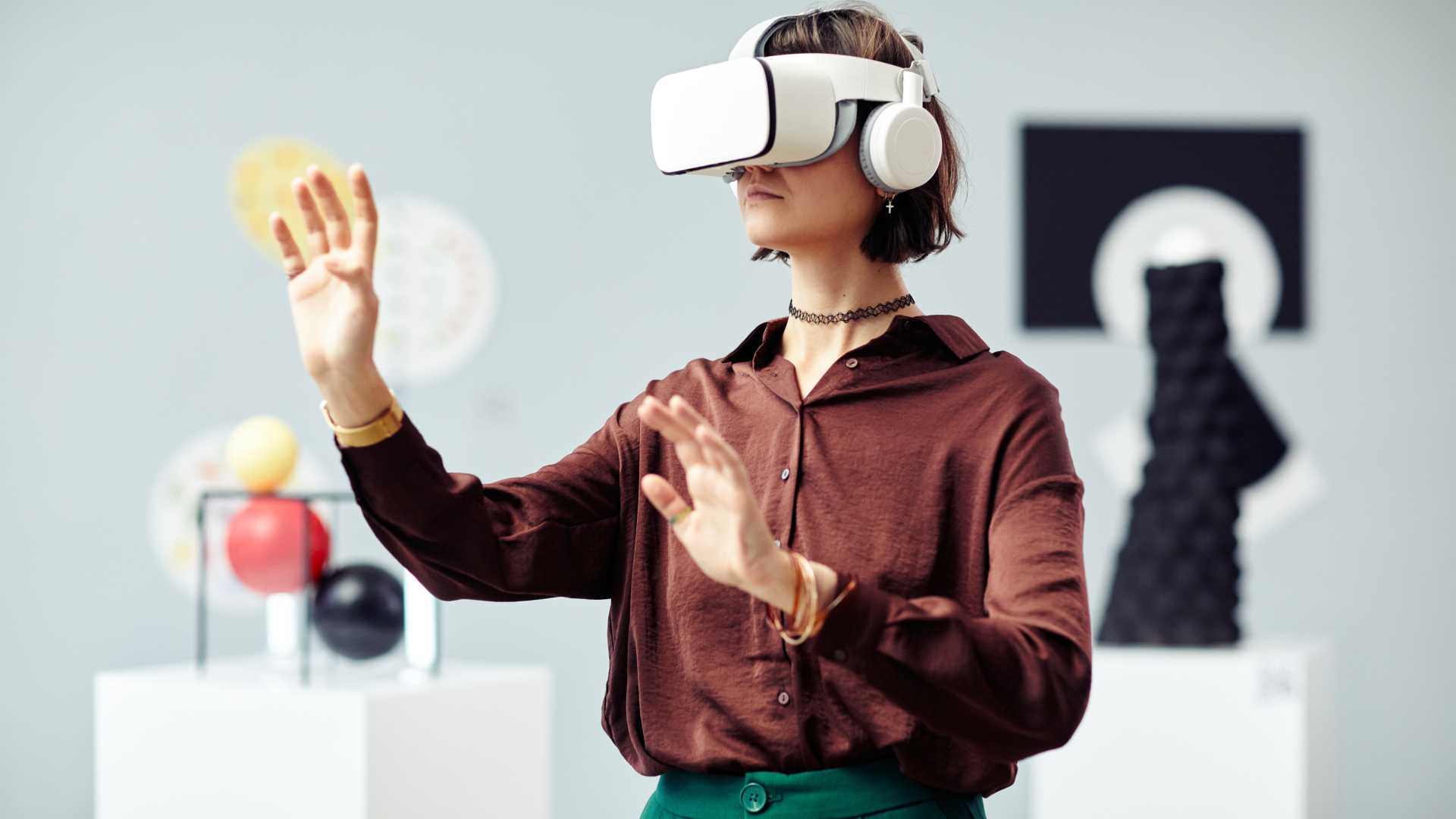 A person is wearing a virtual reality headset with their arms outstretched
