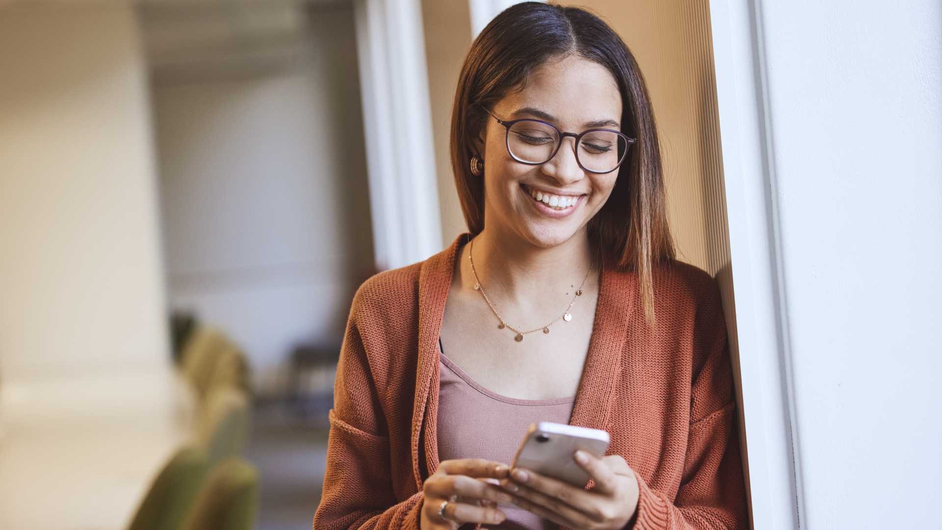 A woman looks at her phone