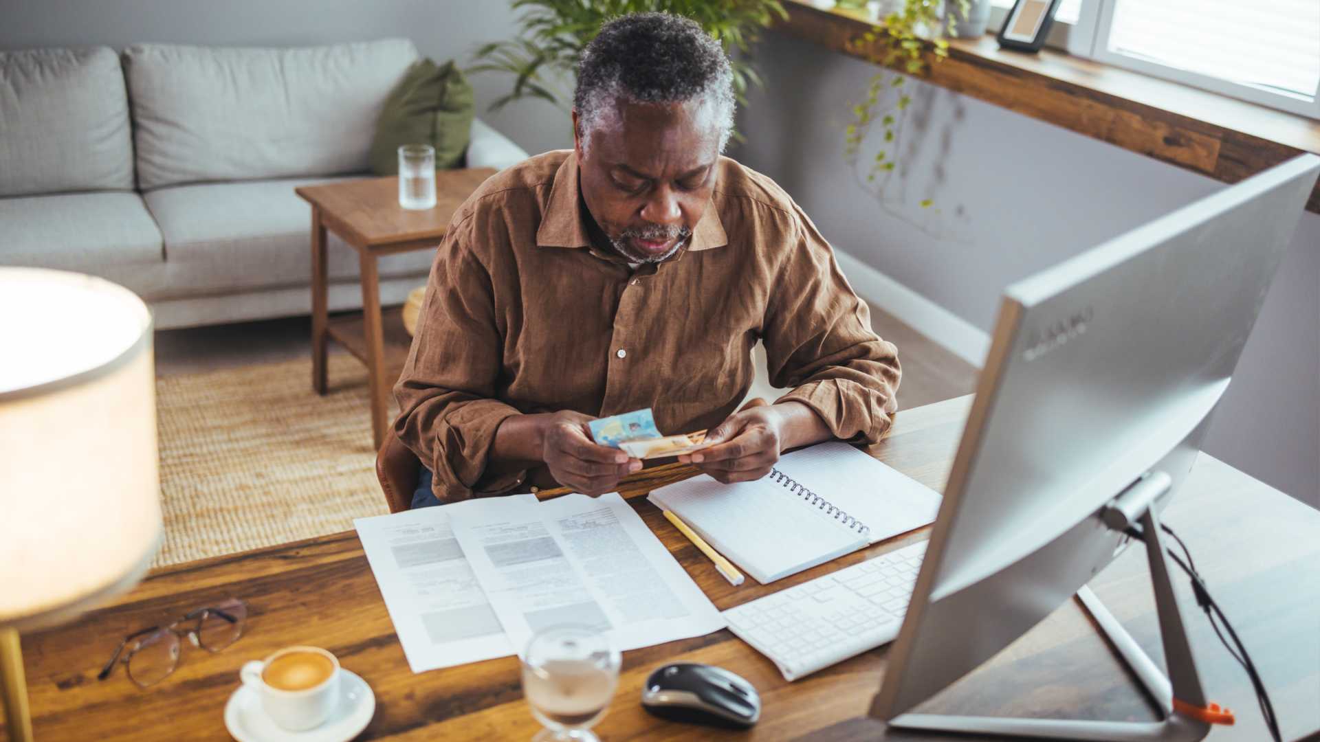 A man sitting at a desk in a work-from-home office setup