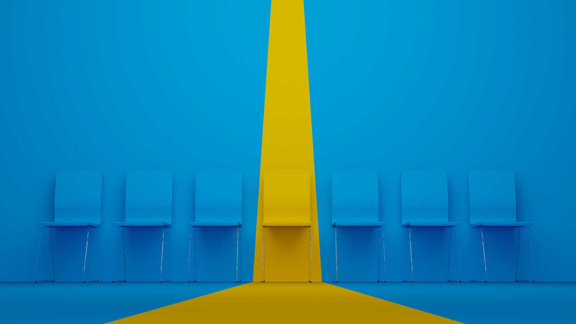Blue chairs lined up against a blue wall with a yellow spotlight over a yellow chair in the middle.