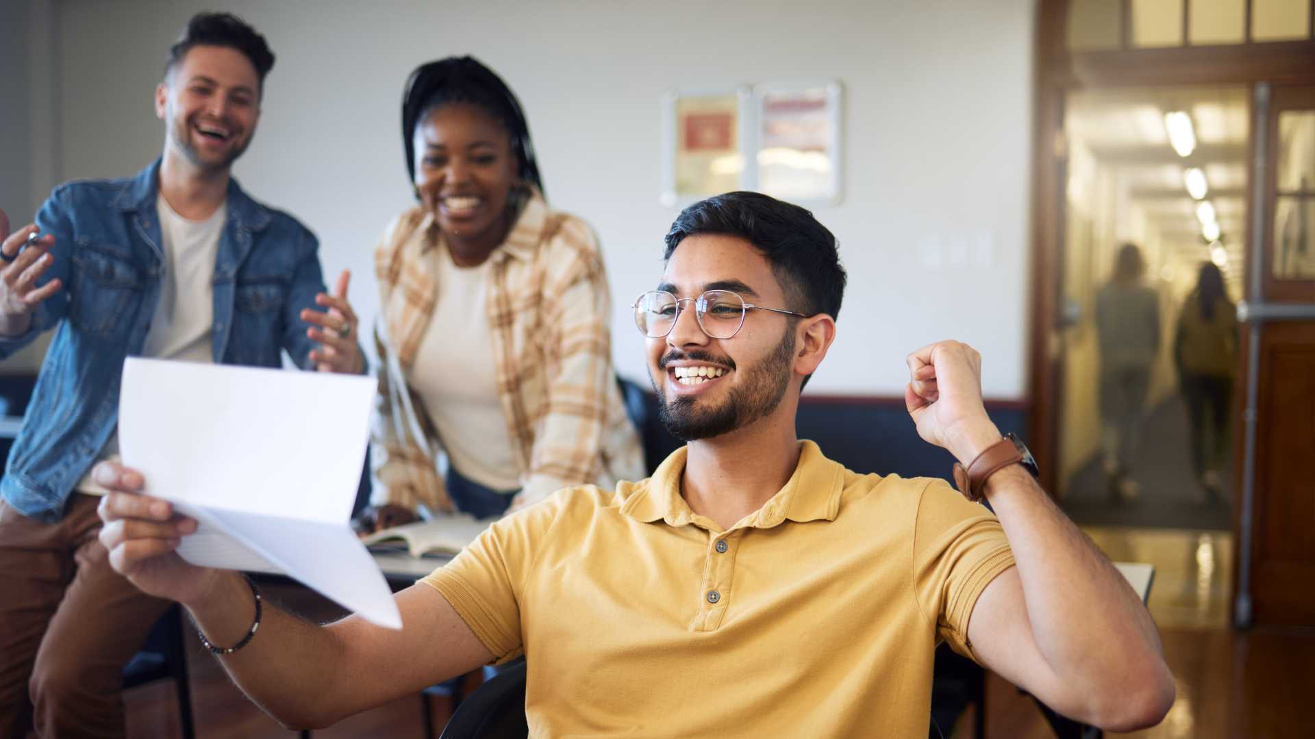 Three colleagues gather looking happy and excited