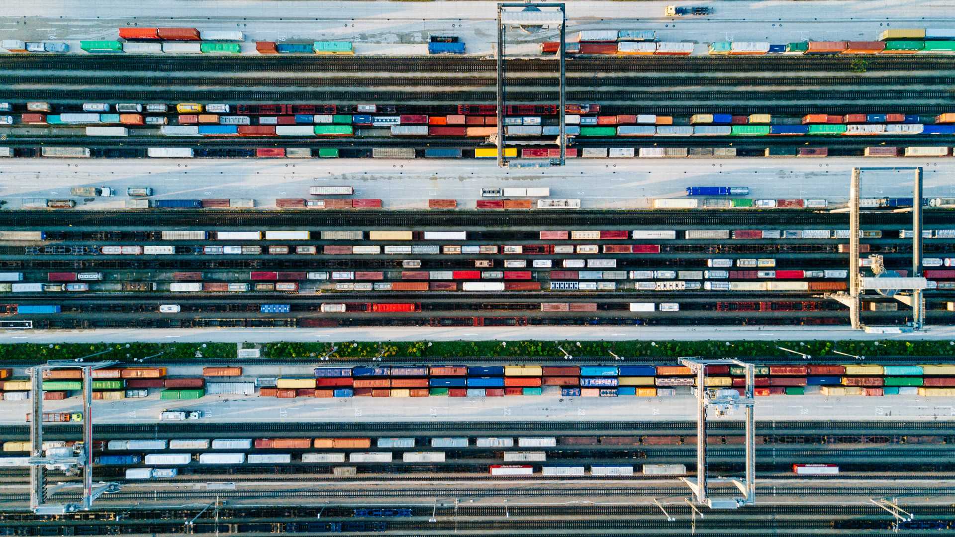 Aerial view of manufacturing plant with large, multi-hued tractor trailers.