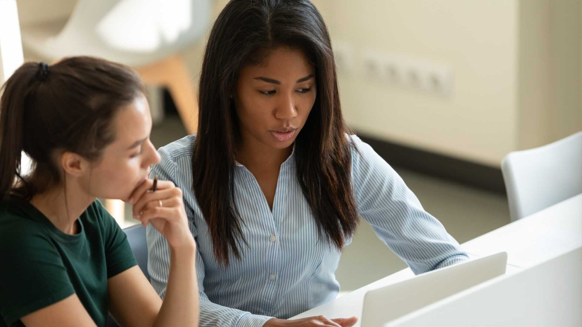 A woman mentors a younger employee