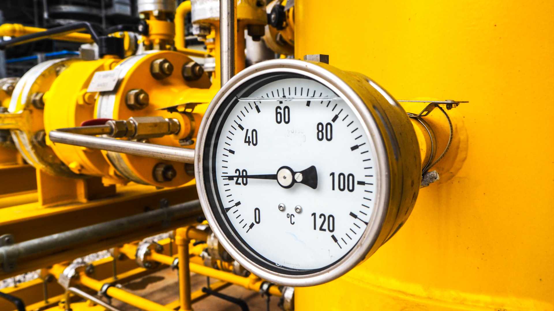 Gauge dial on a yellow pipe