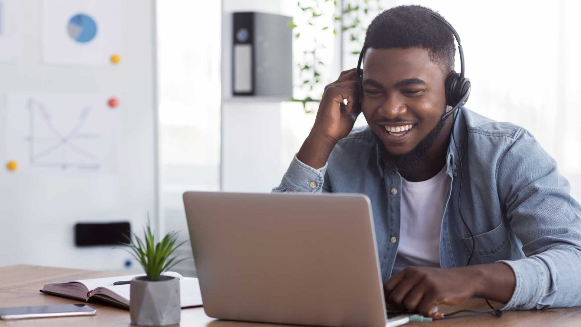 A man on a virtual meeting wearing a headset