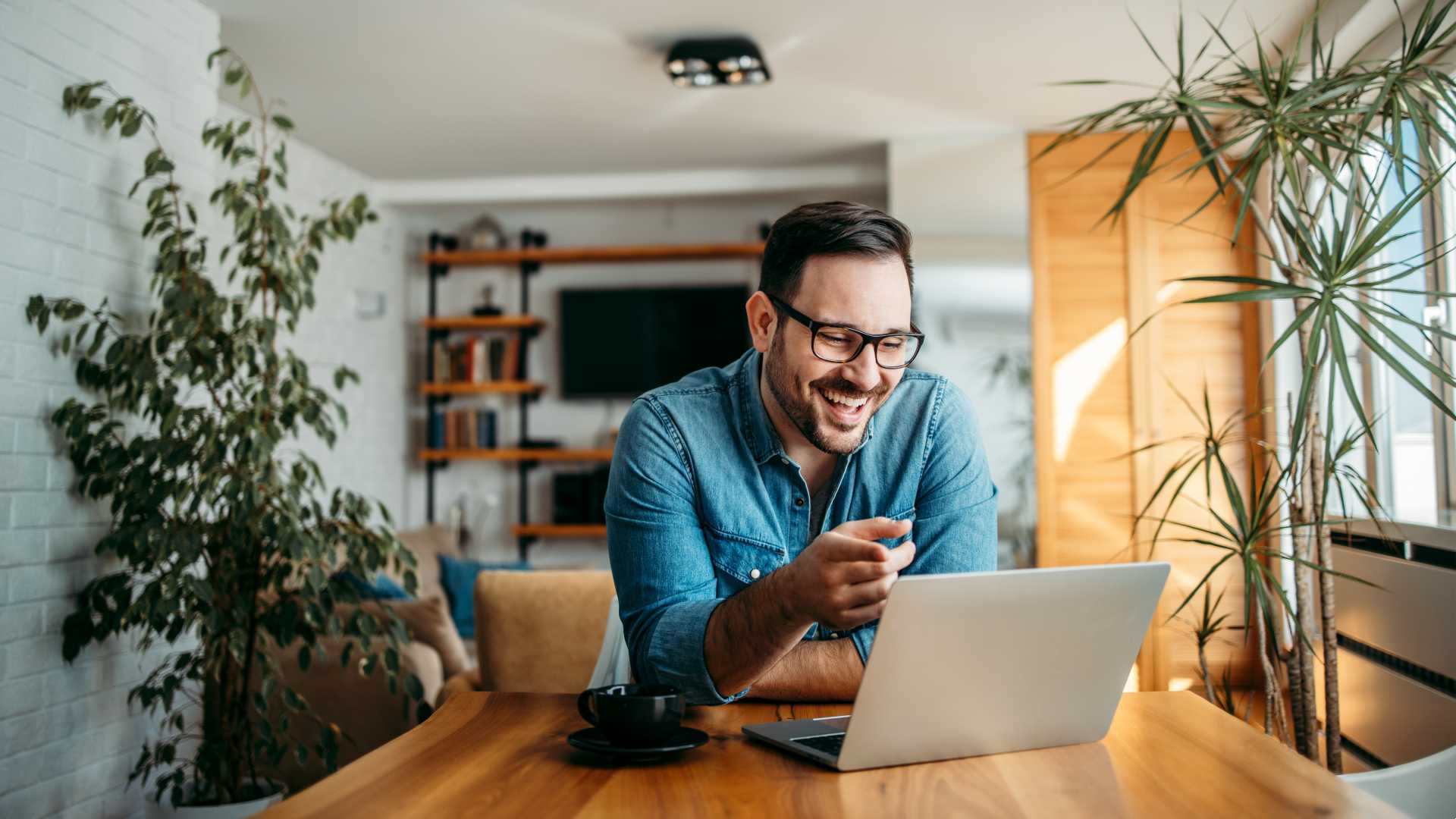 A man smiling on a video call while working from home