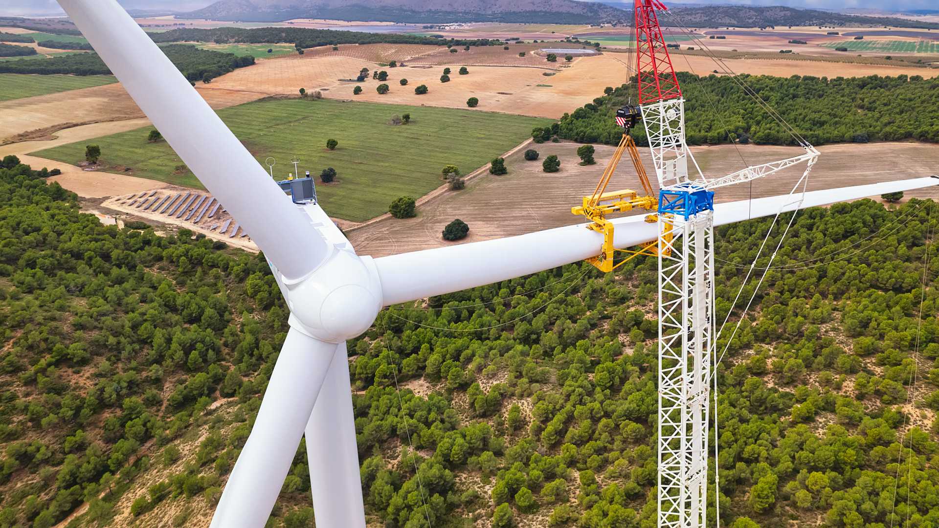 Workers, who have taken part in sustainability training, maintain a windmill.