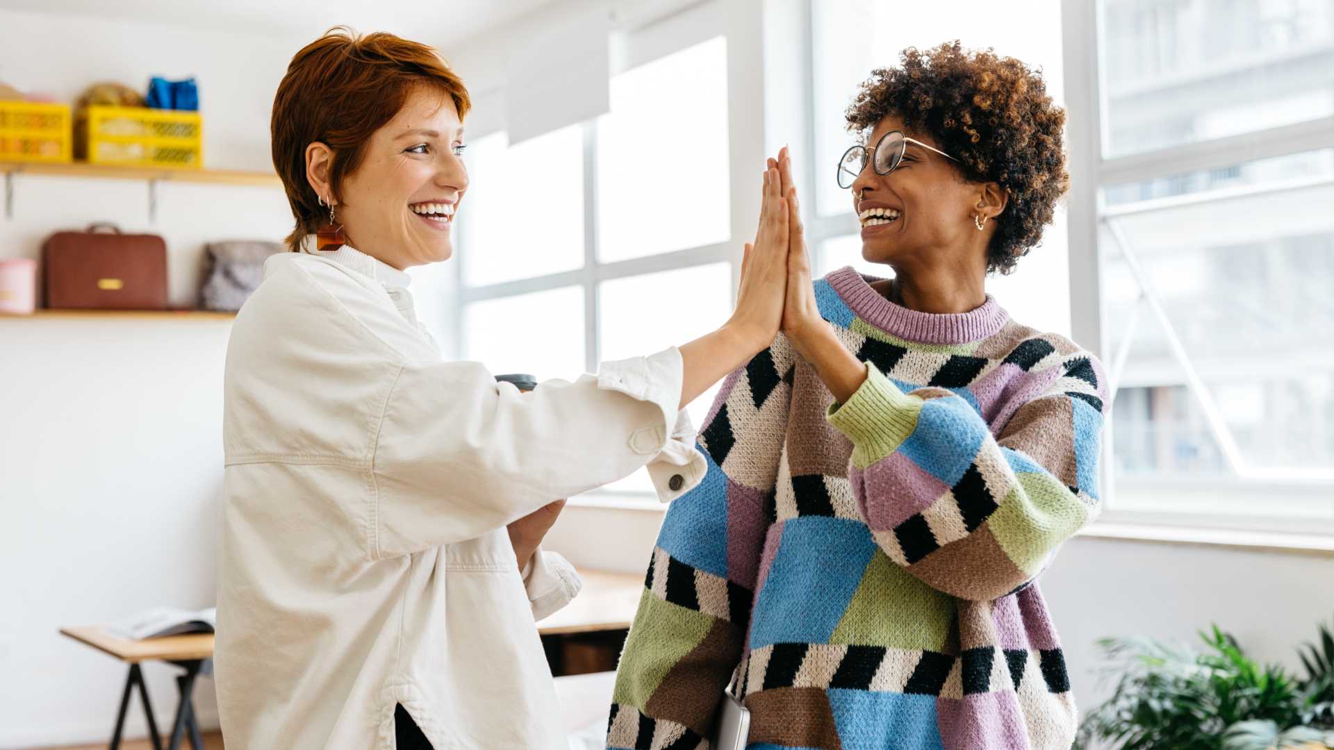 Two female co-workers having good teamwork.