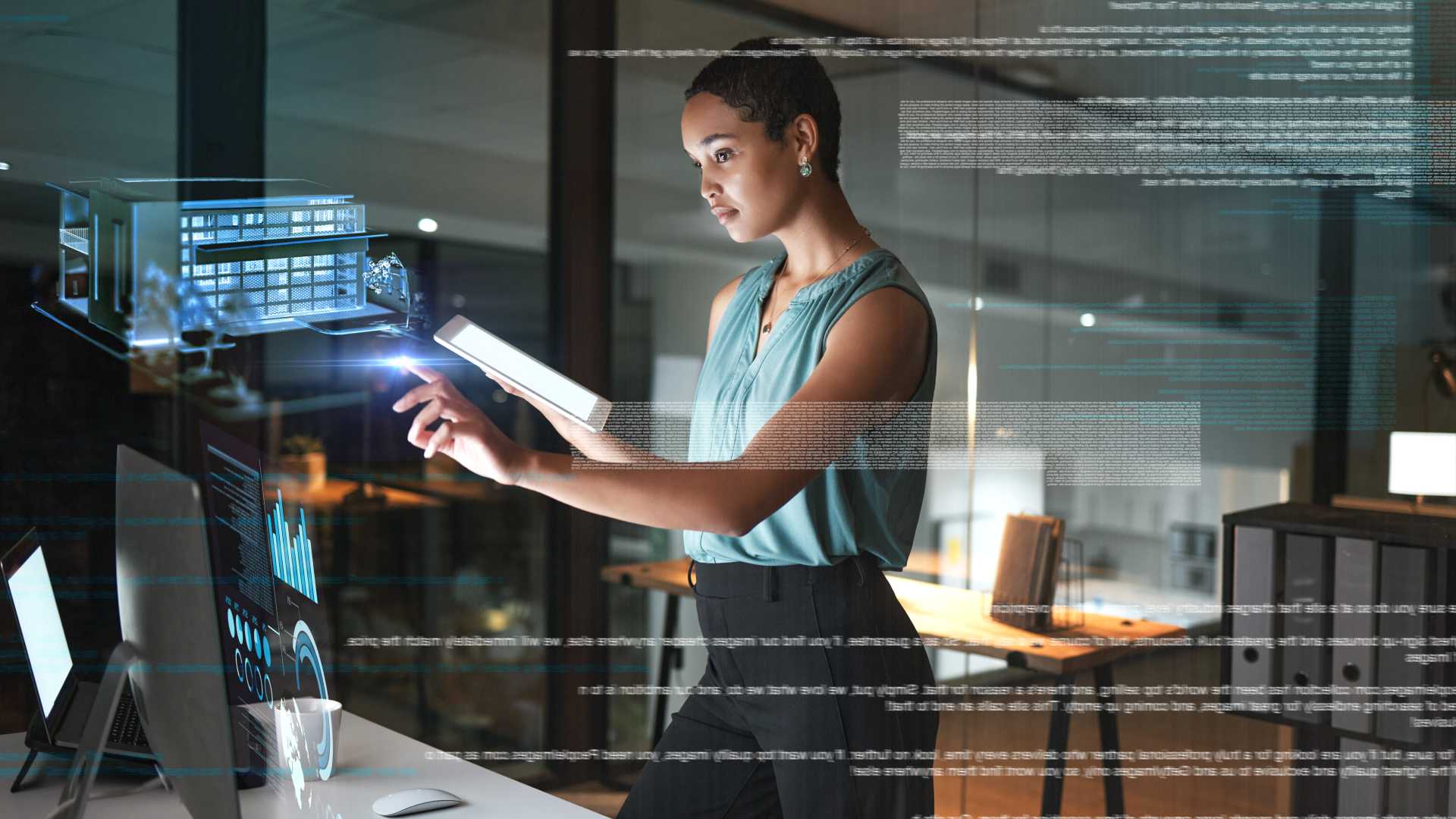 Woman leader hold a tablet in one hand and controlling holographic buttons by a computer screen with the other.