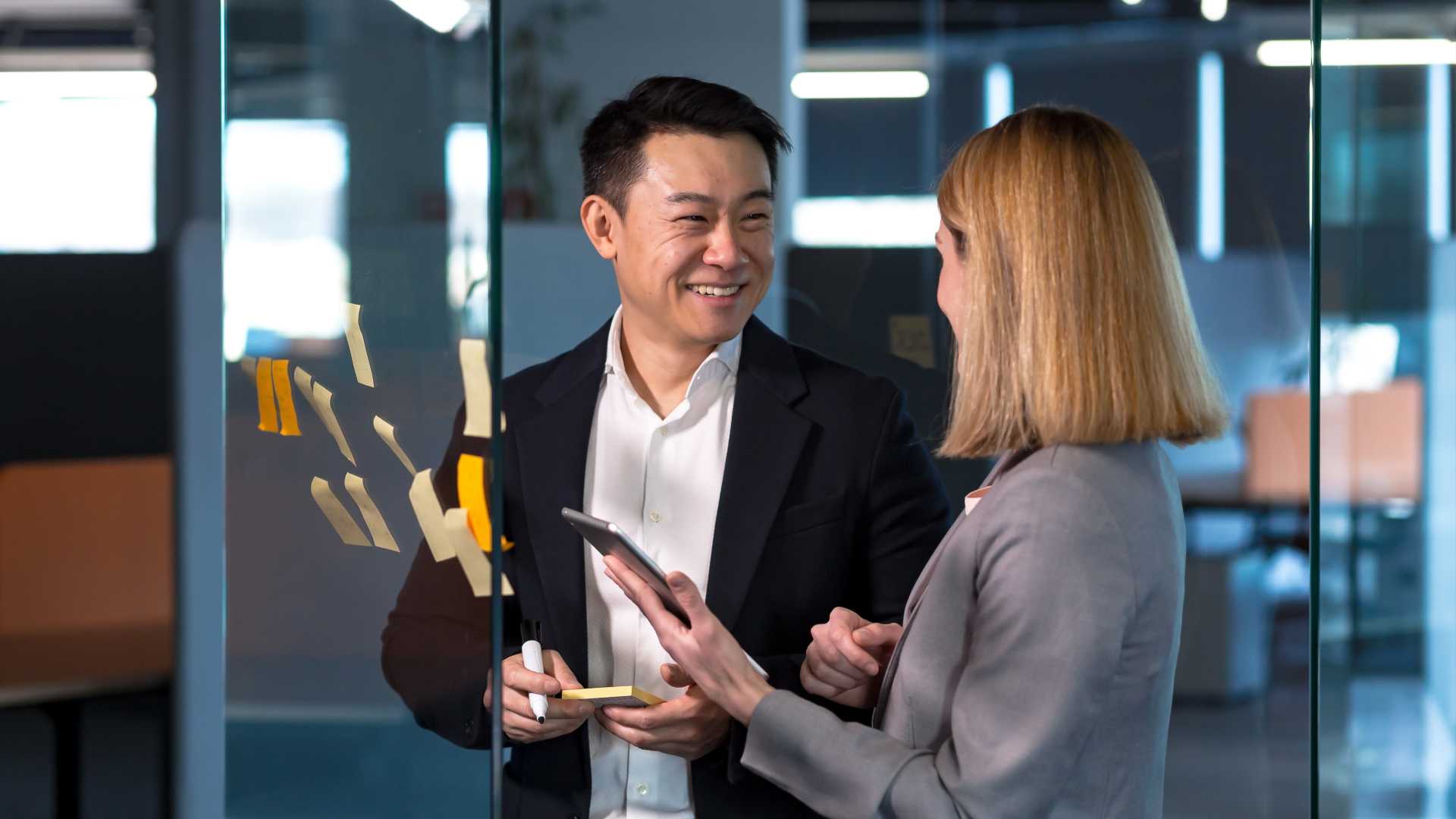 Two employees collaborate in an office environment