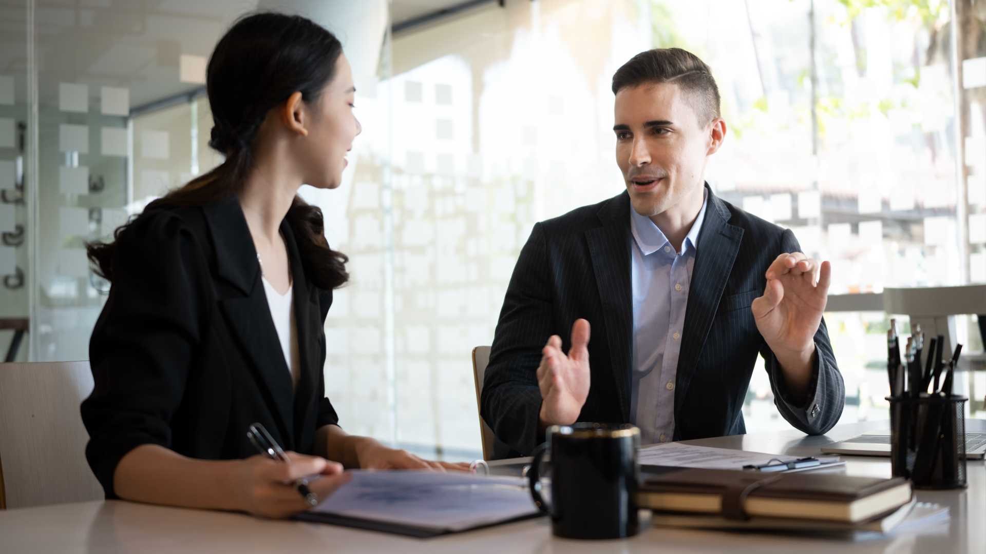 Two businesspeople having a coaching conversation