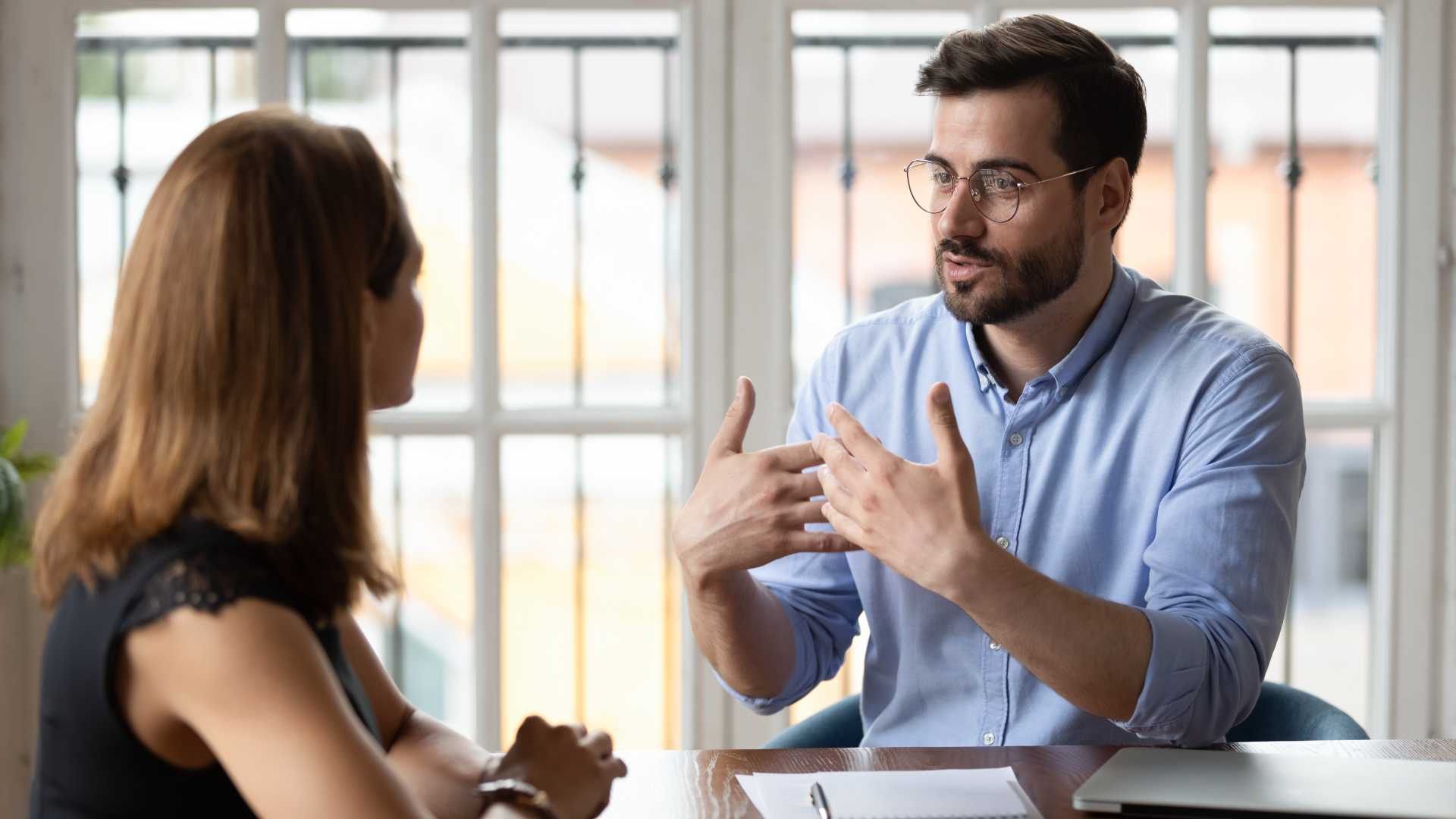 Two people are talking at a table