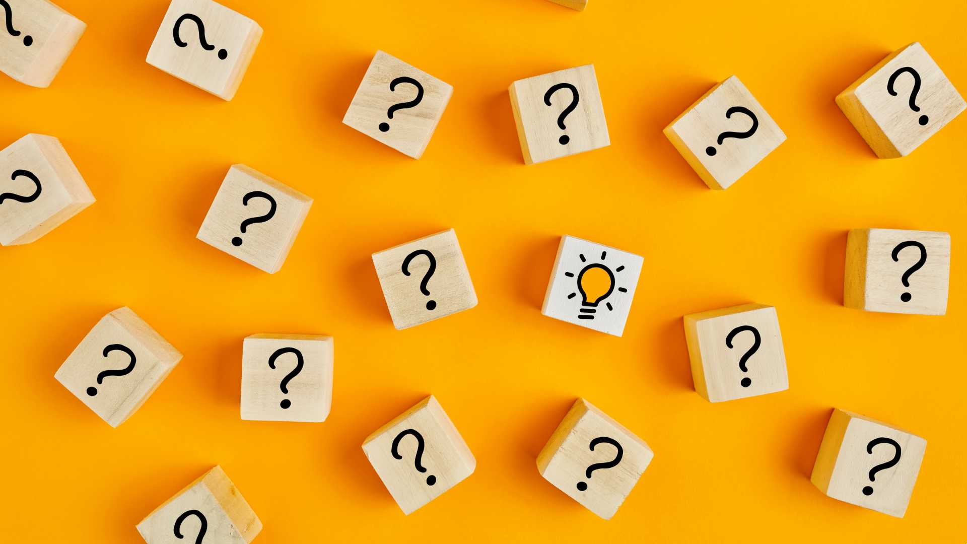A concept image of scrabble-like squares with question marks and one with a lightbulb