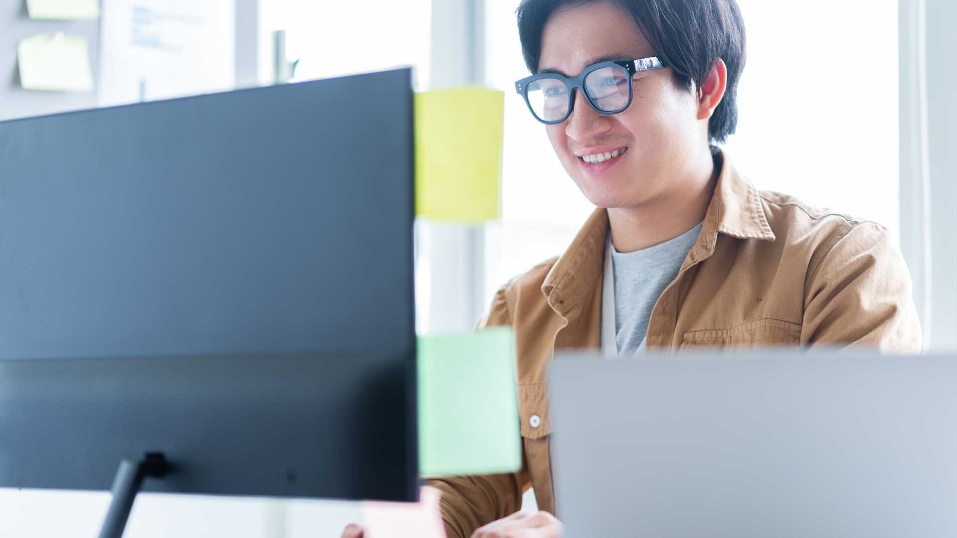 A businessman working in front of a desktop computer