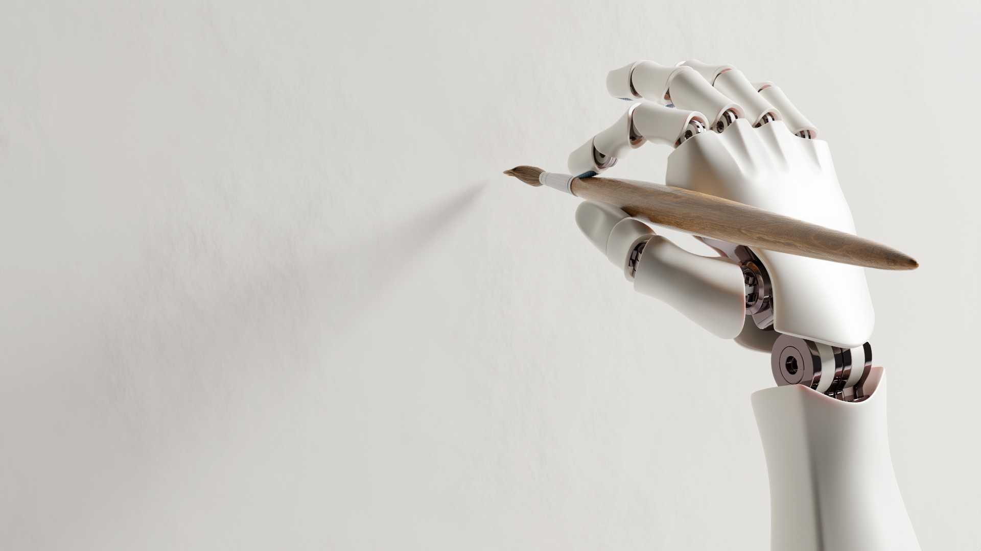Robotic hand drawing with a paintbrush on a white canvas.