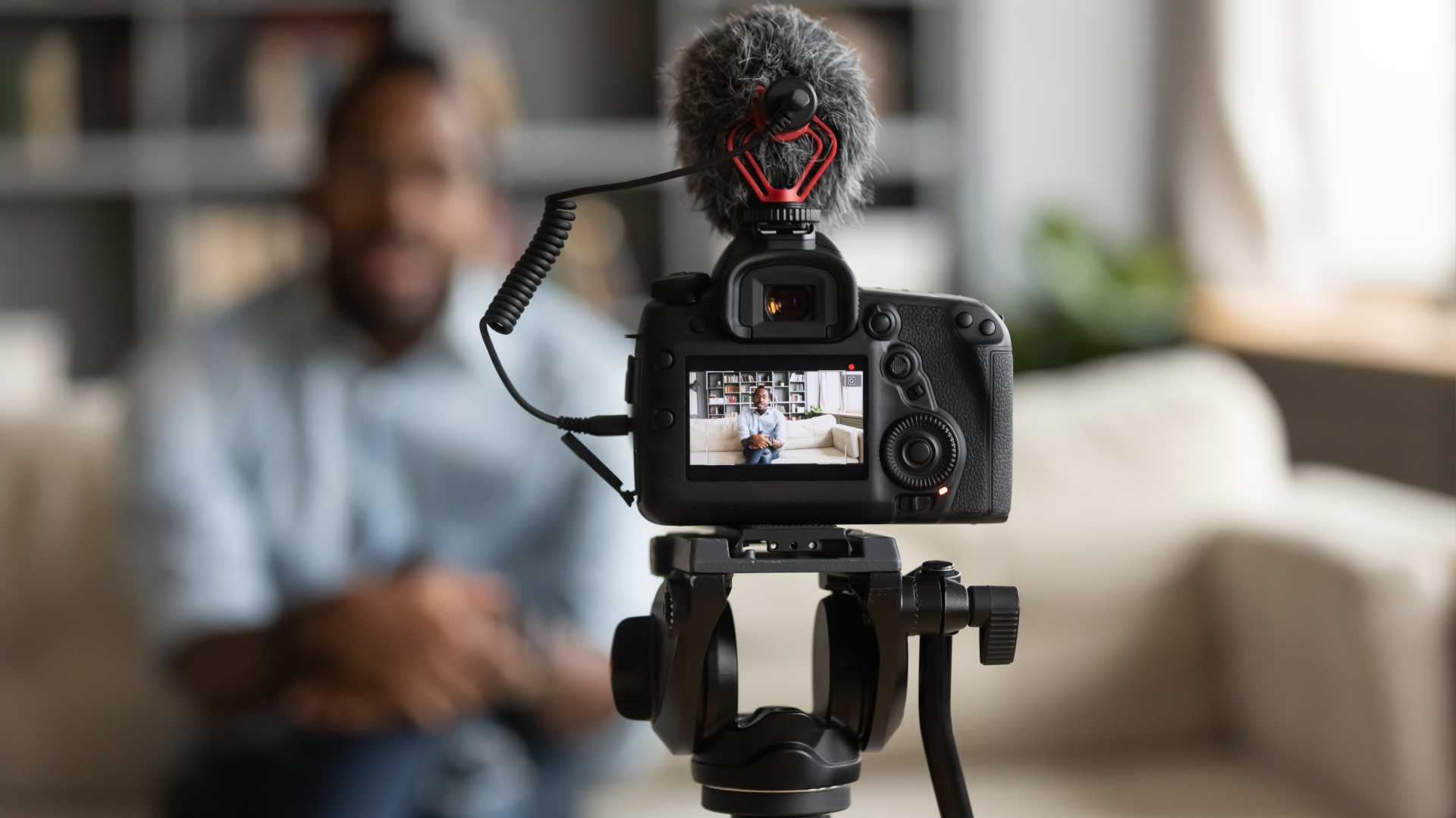a person is sitting in front of a camera recording a video